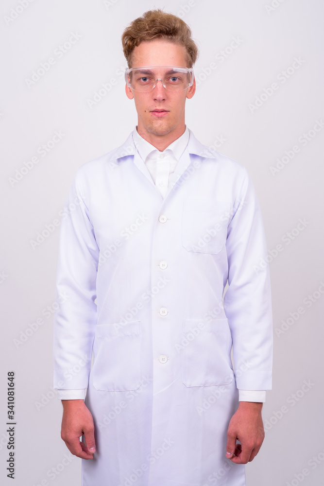 Young handsome Scandinavian man doctor against white background Young handsome Scandinavian man doctor against white background