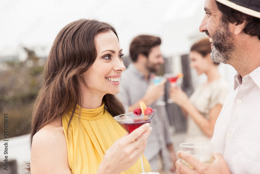 Couple and friends socializing on a cocktail party Couple and friends socializing on a cocktail party