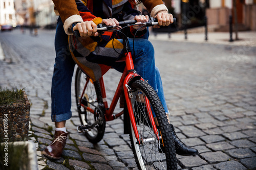 Hands and legs of couple sitting on the bike stock photo