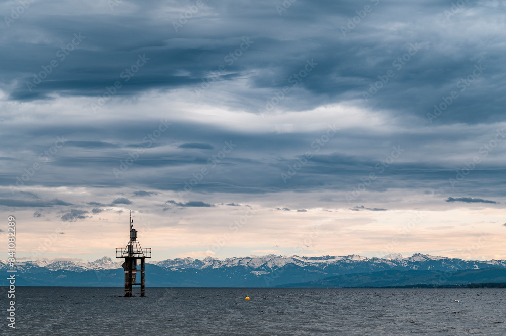 Germany, Baden-Wurttemberg, Gray clouds over Lake Constance and beacon platform Germany, Baden-Wurttemberg, Gray clouds over Lake Constance and beacon platform