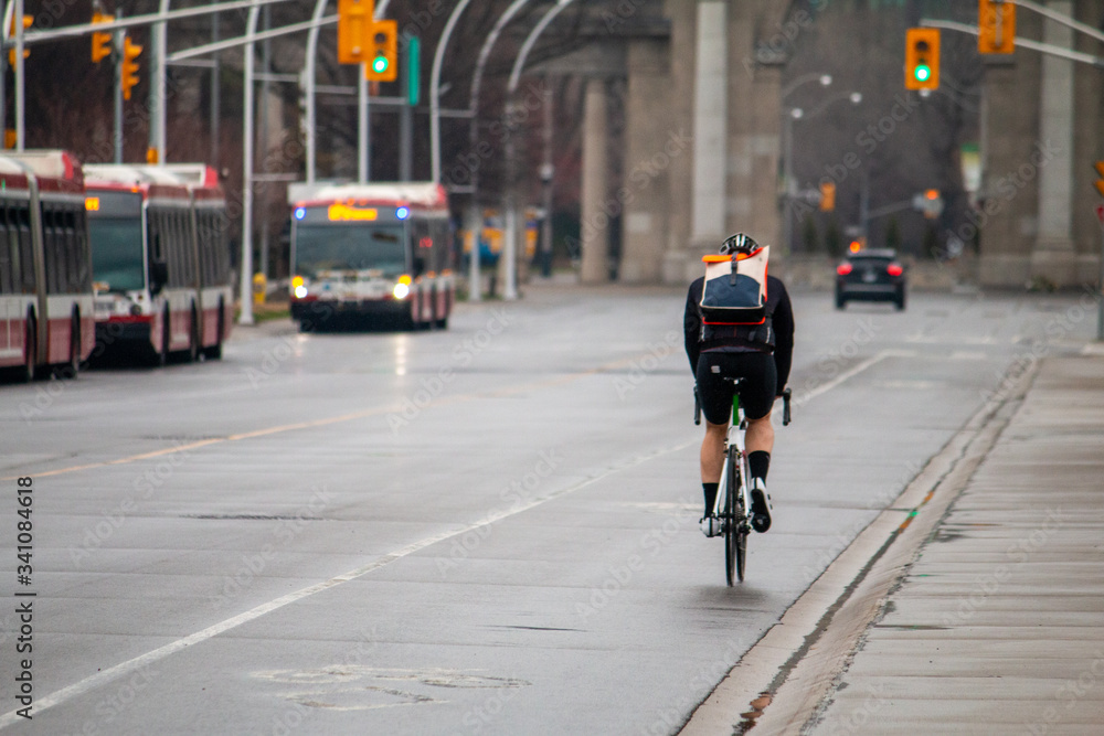 custom made wallpaper toronto digitalCyclist biking through The Exhibition Centre in Toronto. Empty streets. Covid-19.