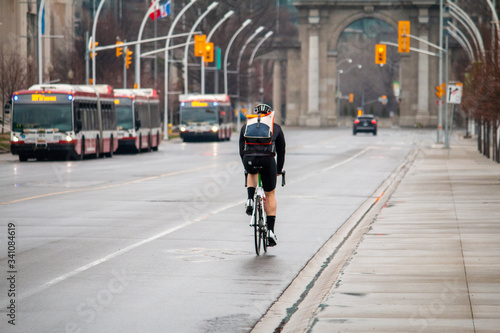Canvas Print Cyclist biking through The Exhibition Centre in Toronto