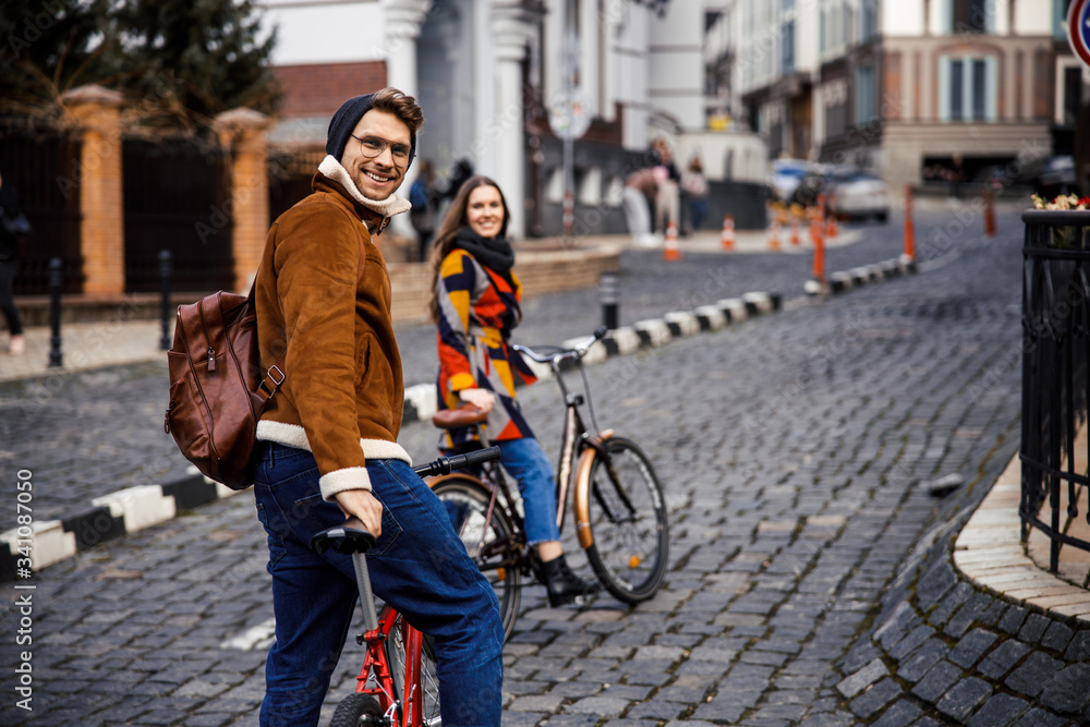 Obraz premium Positive cyclers on spring day in the street looking happy