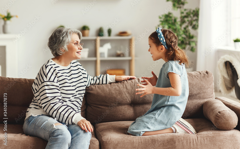 Girl speaking and sharing secret with grandmother. Girl speaking and sharing secret with grandmother.