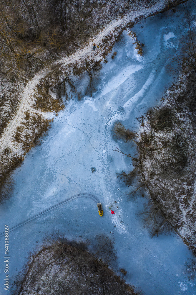 Winter fishing on iced river view from the sky Winter fishing on iced river view from the sky