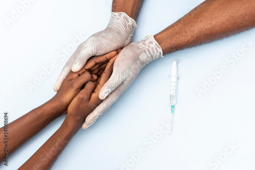 african doctor holding a patient, giving instructions and support