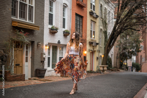 female traveler walking the colorful streets of downtown georgetown in washington DC photo