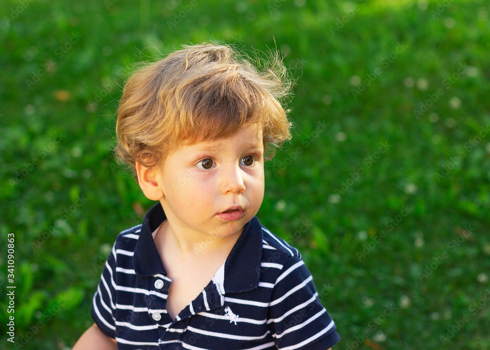 Cute little boy outdoors. A child plays in the yard. Cute little boy outdoors. A child plays in the yard.