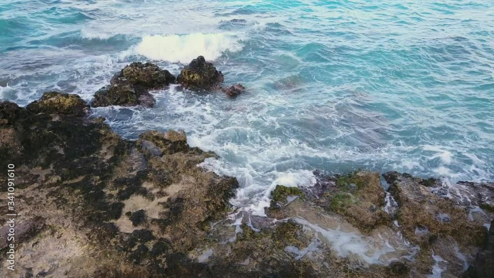 Amazing Blue turquoise waves crashing over the rocky coastline on a sunny day in South Pacific vacation island paradise Rangiroa, French Polynesia Amazing Blue turquoise waves crashing over the rocky coastline on a sunny day in South Pacific vacation island paradise Rangiroa, French Polynesia