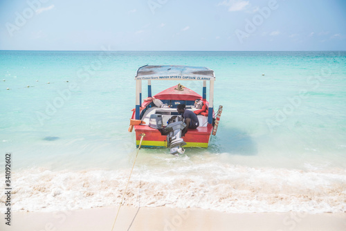 colorful boat docked on the bright blue waters of the caribbean sea