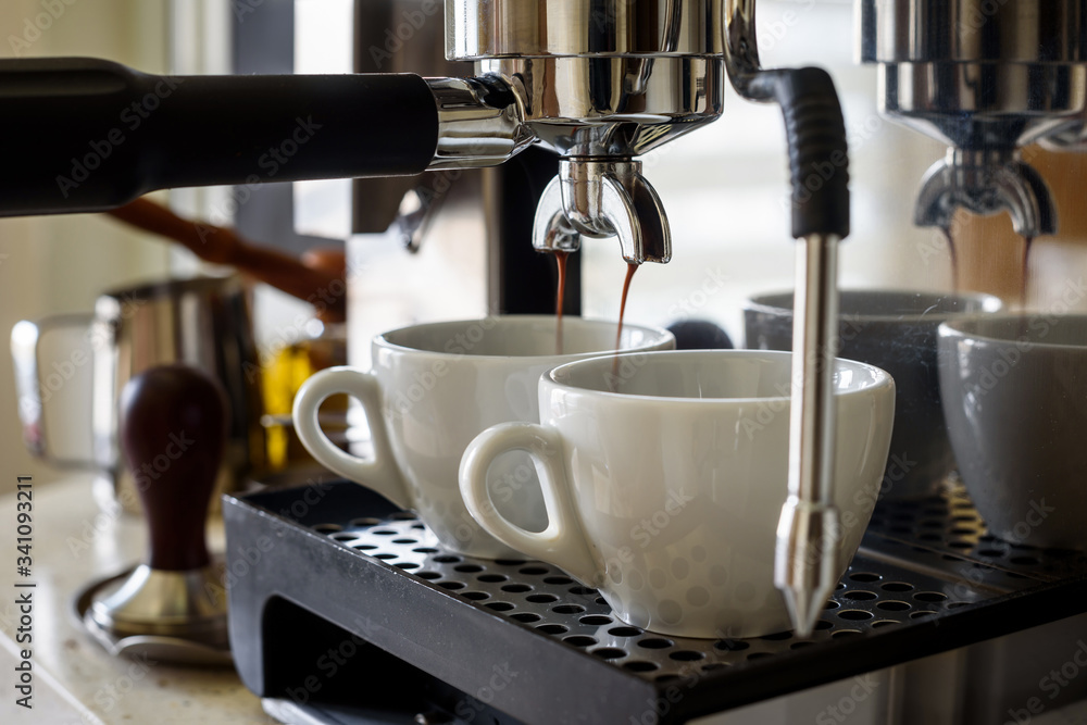 Preparing two cups of coffee on an espresso machine. Preparing two cups of coffee on an espresso machine.