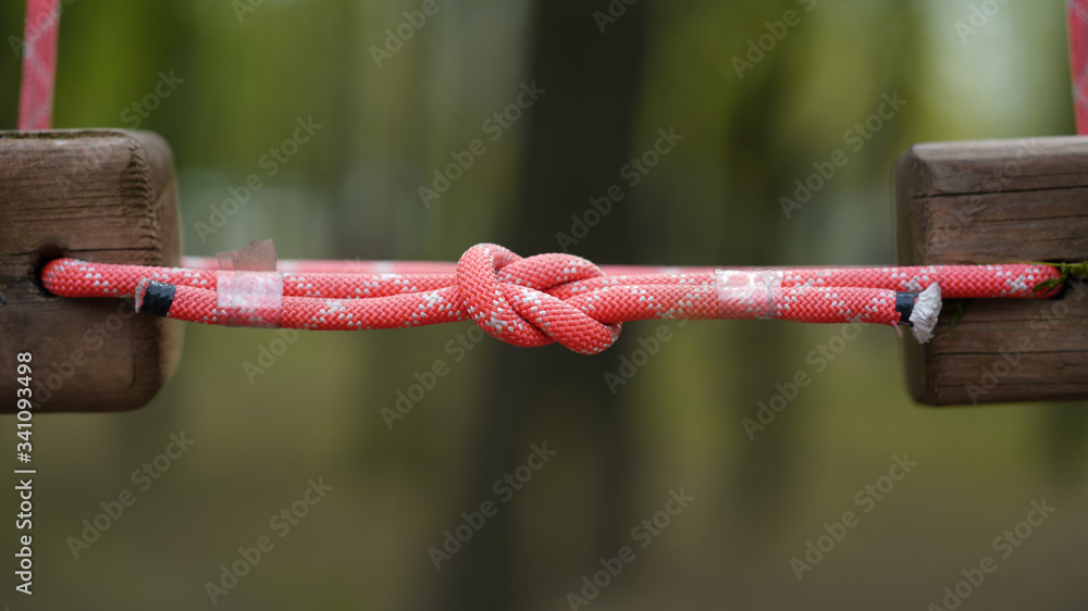 Knot on red ropes in a rope road