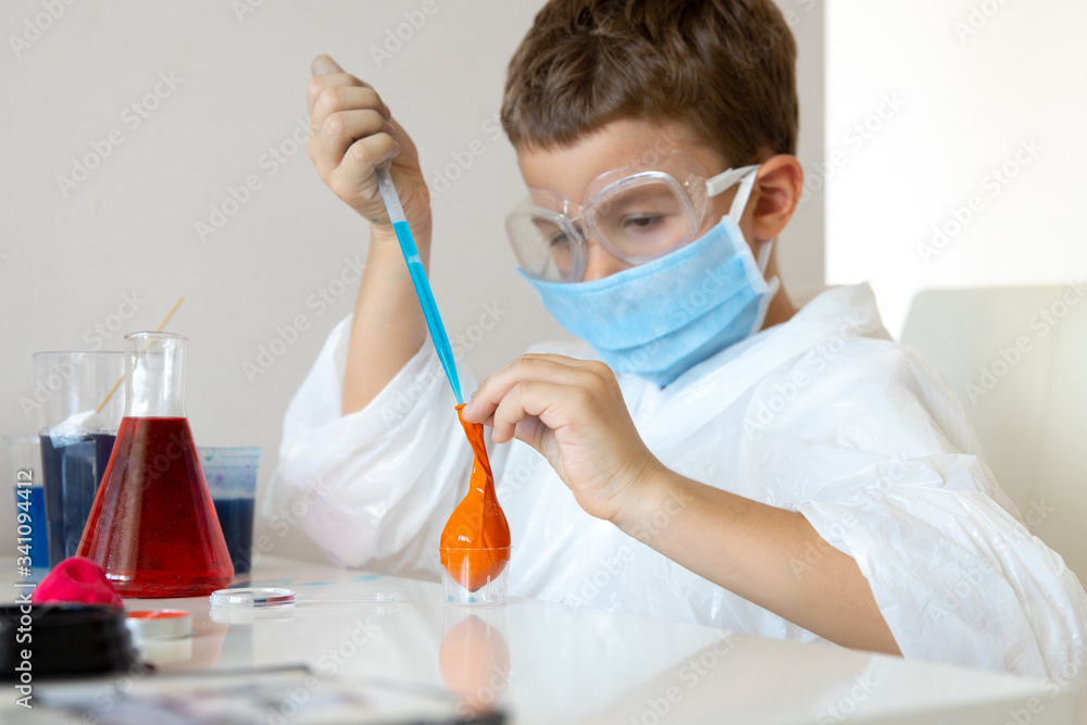 Little boy using home laboratory in free time Little boy using home laboratory in free time