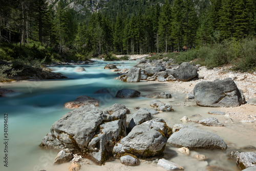 Rapid river flowing through the valley in the Italian Dolomites