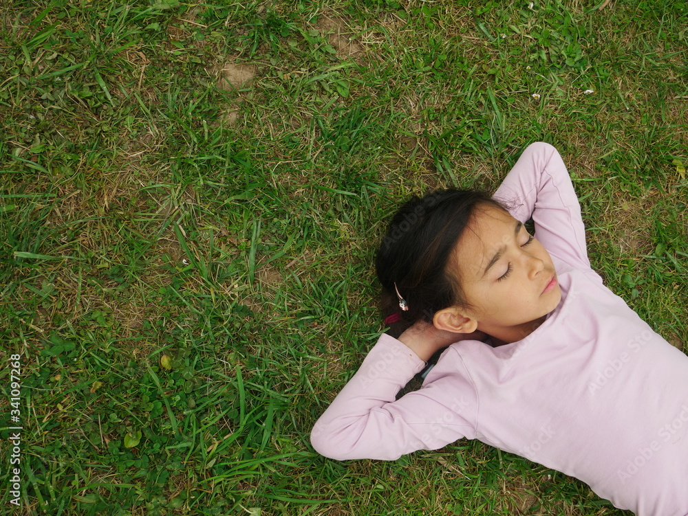 Métis little girl sleeping on the grass Métis little girl sleeping on the grass