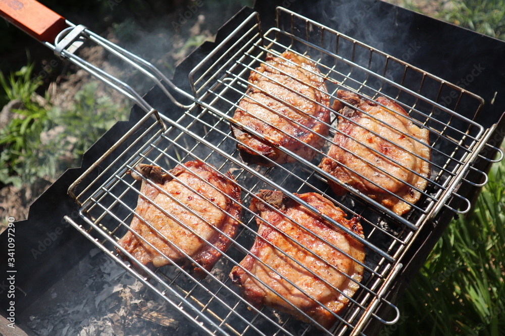 Pork steaks cooked on a charcoal grill outdoors