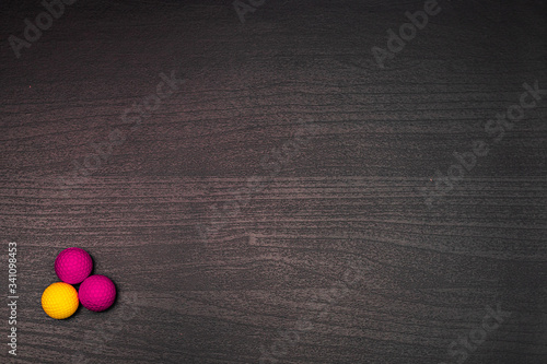 Colorful balls on dark wooden table