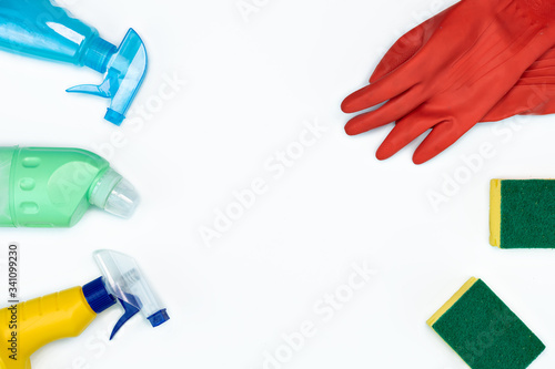 flat-lay of Cleaning supplies on white background. Detergents bottles with cleaning liquid with copy space and top view