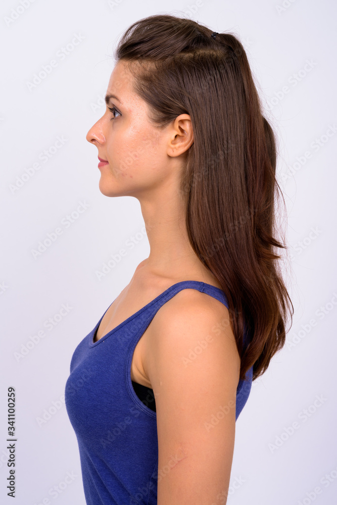 Profile view of young beautiful woman wearing tank top Profile view of young beautiful woman wearing tank top