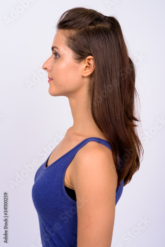 Profile view of young beautiful woman wearing tank top