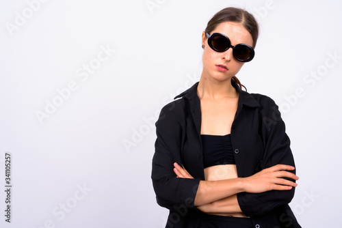 Young beautiful woman as secret agent against white background