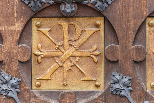 Door with a bas-relief in the Basilica of Brno. Bas-relief with the coat of arms on the large door to the Church.