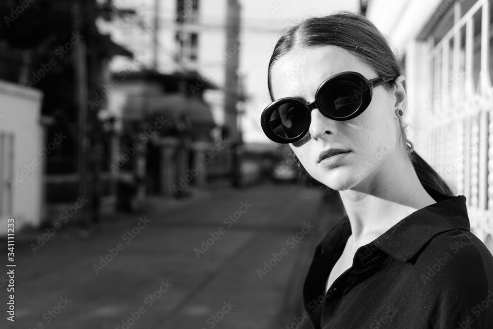 Portrait of young beautiful woman in the city streets outdoors in black and white Portrait of young beautiful woman in the city streets outdoors in black and white