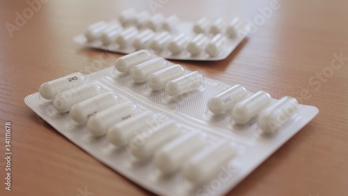 Packaging of tablets and pills on the table. Selective focus on pills, tablets, vitamins, drugs, capsules, medicament and food supplement for health care. Medicine. Pharmaceutical industry. 