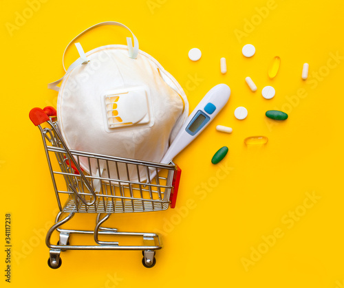 Online shopping and Express delivery medicines. Concept online pharmacy. Medical mask, tablets, thermometer. Copy space. Fast and free Delivery transport. Isolated yellow background photo