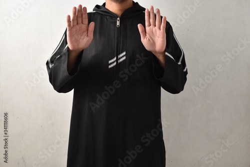 asian muslim man solat and takbir take his hands up. islam praying. photo