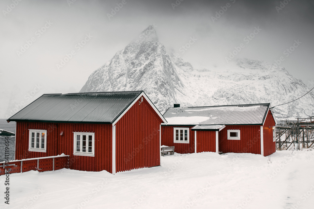 Red cabins on a snowy Sakrisoy island, Norway