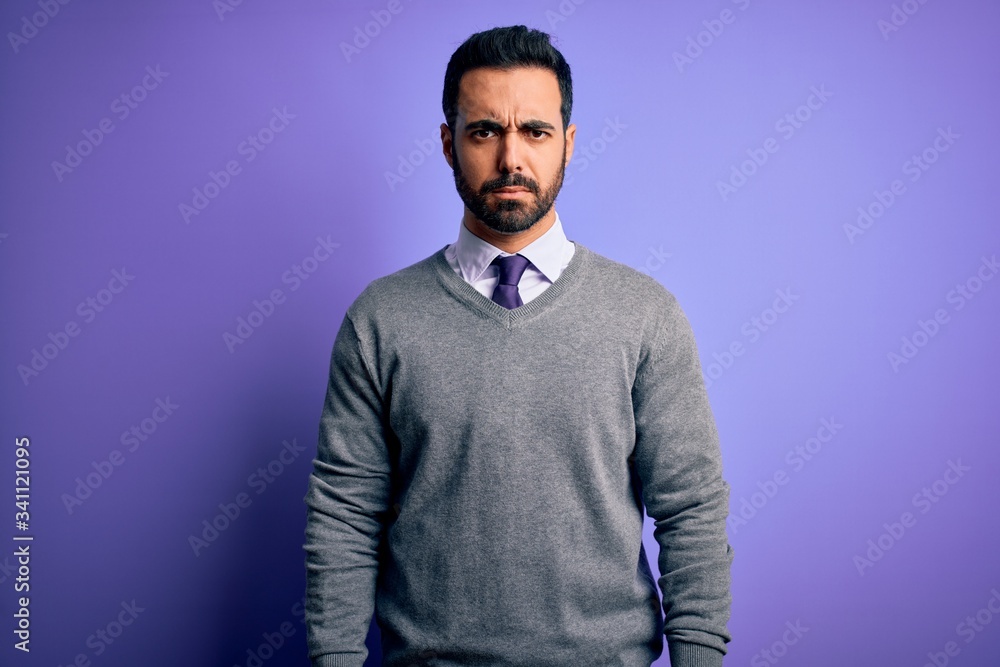 Handsome businessman with beard wearing casual tie standing over purple background skeptic and nervous, frowning upset because of problem. Negative person. Handsome businessman with beard wearing casual tie standing over purple background skeptic and nervous, frowning upset because of problem. Negative person.