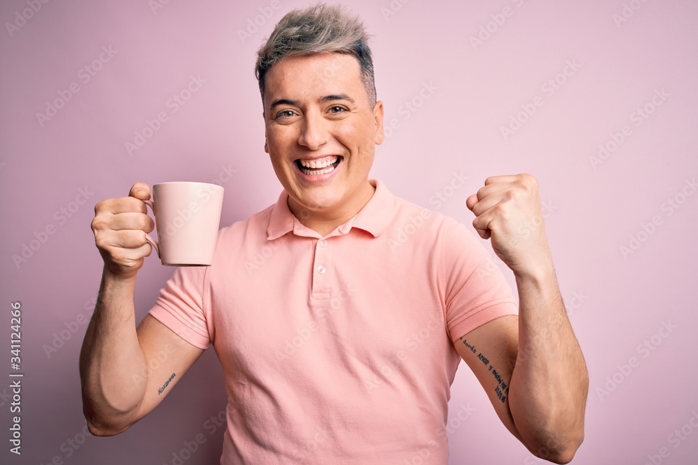 Young modern handsome man drinking a cup of hot coffee over isolated pink background screaming proud and celebrating victory and success very excited, cheering emotion Young modern handsome man drinking a cup of hot coffee over isolated pink background screaming proud and celebrating victory and success very excited, cheering emotion