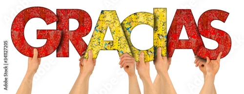 people holding up colorful red yellow spain flag wooden letter with spanish word gracias ( english translation: thank you ) isolated white background.  thankful grateful respect rewarding concept
