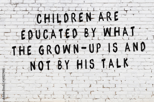 Tablou pe pânză White brick wall with painted black inscription of wise quote
