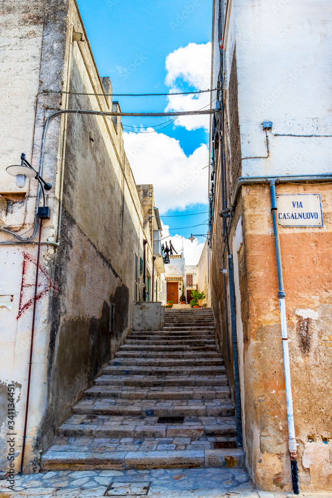 Narrow stairway street in the old town of Matera, Province of Matera, Basilicata Region, Italy. Translation - Casalnuovo Street