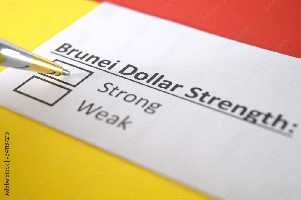 One person is answering question about strength of Brunei Dollar. One person is answering question about strength of Brunei Dollar.