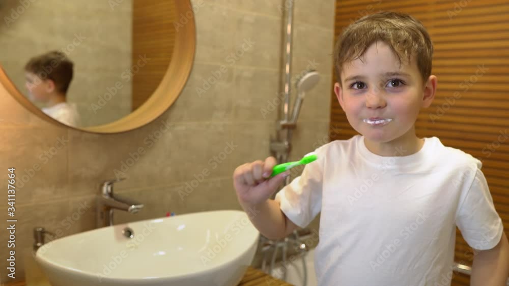 little boy brushing his teeth and making faces at the camera little boy brushing his teeth and making faces at the camera