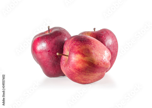 A set of three fresh red apples with drops isolated on white background