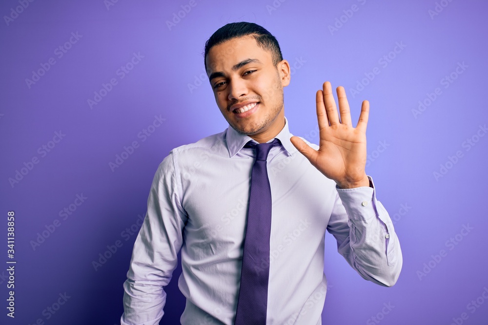 Young brazilian businessman wearing elegant tie standing over isolated purple background Waiving saying hello happy and smiling, friendly welcome gesture Young brazilian businessman wearing elegant tie standing over isolated purple background Waiving saying hello happy and smiling, friendly welcome gesture