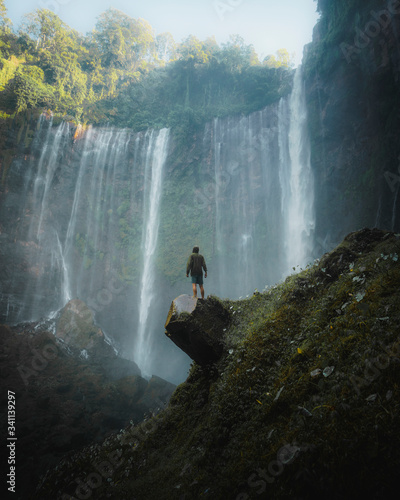 Man standing by Tumpak Sewu Waterfalls