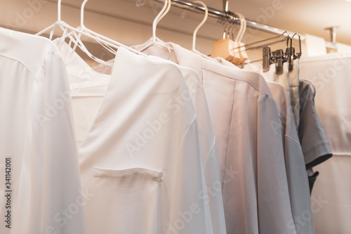White women's shirts hanging in the wardrobe