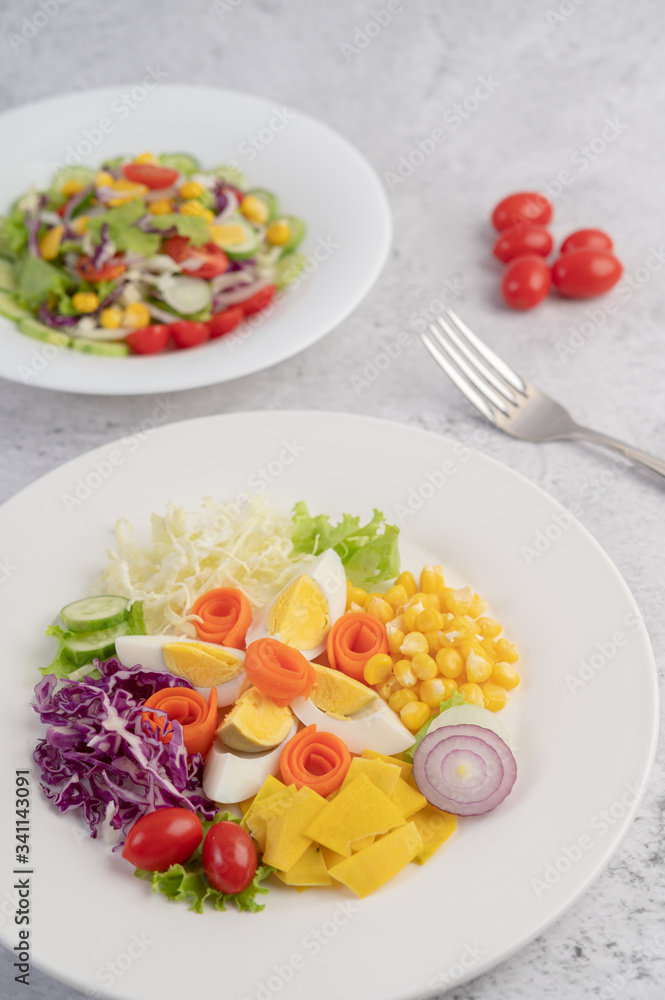 Vegetable salad with boiled eggs in a white dish.
