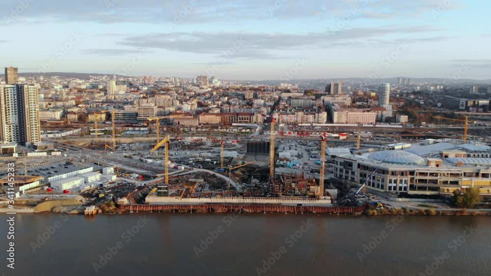 Drone video of a large construction site on the waterfront of Belgrade, Serbia. City skyline, dusk sky. Drone video of a large construction site on the waterfront of Belgrade, Serbia. City skyline, dusk sky.