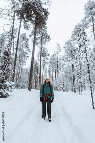 Woman trekking through the snow in Lapland, Finland