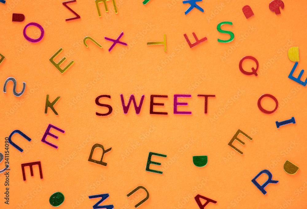 Sweet spelled word with alphabets background Sweet spelled word with alphabets background