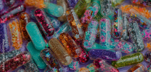 Closeup of glittery shimmery shiny pills capsule background