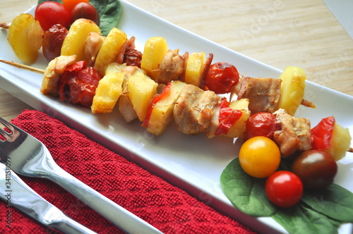 BBQ grilled chicken vegetable kebab skewers ready to eat served on a plate photo