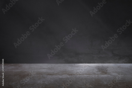 Dark gray wall with a concrete floor