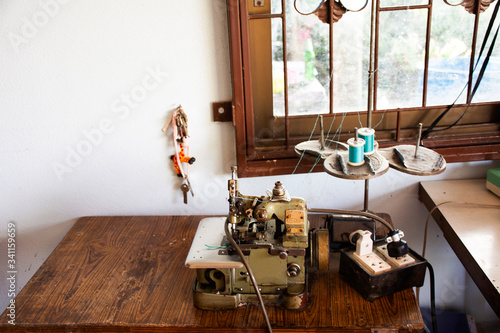 Classic vintage antique retro overlock and safety stitch machine sewing for thai people work at home in countryside on August 20, 2019 in Phatthalung, Thailand photo